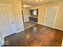 Open-concept living area with refinished hardwood floors and fresh paint at 2624 E 17Th St, Indianapolis, IN 46218