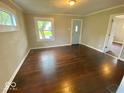 Sunlit living room with hardwood floors and a view of the front yard at 2624 E 17Th St, Indianapolis, IN 46218