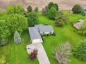Overhead shot features the home nestled among mature trees on a spacious lot at 3020 E 400 S, Lebanon, IN 46052