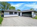 Picture of the attractive, recently renovated, single-story home with a gray stone driveway at 3237 Thurston Dr, Indianapolis, IN 46224