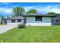 A nice looking single-story home with white siding and a green lawn, with nice landscaping at 3237 Thurston Dr, Indianapolis, IN 46224