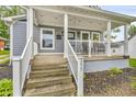 Inviting front porch with white railings and steps leading up to the entrance at 353 S Indiana St, Danville, IN 46122