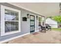 Welcoming front porch with rocking chairs, a blue door and updated lighting fixtures at 353 S Indiana St, Danville, IN 46122