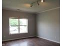 Bedroom featuring hardwood floors and a large window at 3908 Roundwood Dr, Indianapolis, IN 46235