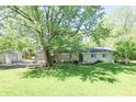 Charming home with a well-manicured lawn and a detached garage, set amidst mature trees for privacy at 4023 Cedar Hills South Dr, Greenwood, IN 46143