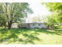 Well-kept single-story home with lush green lawn and mature shade trees, providing a tranquil setting at 4023 Cedar Hills South Dr, Greenwood, IN 46143