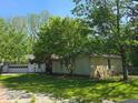 Charming single-story home with a well-manicured lawn and mature trees at 4115 Tansel Rd, Indianapolis, IN 46234