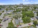 Wide angle aerial view of neighborhood with the subject home and the Kansas City skyline in the distance. Locator pin indicates location at 418 Harlan St, Indianapolis, IN 46201