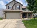 Lovely two-story home featuring brick accents, a two-car garage, and a welcoming entrance at 5241 Waterton Lakes Dr, Indianapolis, IN 46237
