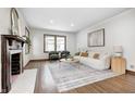 Cozy living room featuring a decorative fireplace, neutral color palette and hardwood floors at 5809 N Illinois St, Indianapolis, IN 46208