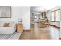 Inviting open-concept layout with hardwood floors, bright lighting and a view into the kitchen at 5809 N Illinois St, Indianapolis, IN 46208