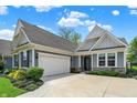 Beautiful home exterior highlighting a two-car garage and elegant stonework at 5850 Lyster Ln, Indianapolis, IN 46239