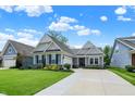 Inviting home exterior showcasing well-manicured lawn, complemented by stone accents and detailed trim at 5850 Lyster Ln, Indianapolis, IN 46239