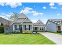 Charming home featuring a lush, well-maintained front yard and a classic exterior design at 5850 Lyster Ln, Indianapolis, IN 46239