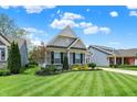 Attractive home with manicured lawn, mature landscaping, and a classic architectural style at 5850 Lyster Ln, Indianapolis, IN 46239