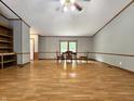 Spacious living room with light wood laminate flooring, with natural light, neutral paint and wood trim at 6538 N Tutterow Rd, Monrovia, IN 46157