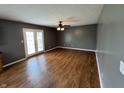 Spacious living room with hardwood floors, ceiling fan, and access to the backyard through glass patio doors at 660 White Ash Trail, Mooresville, IN 46158