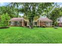 Charming one-story home with a beautiful front lawn, mature trees and brick exterior at 6605 Grosvenor Pl, Indianapolis, IN 46220