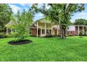 Well-manicured front yard with mature trees and beautiful landscape at 6605 Grosvenor Pl, Indianapolis, IN 46220