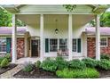 Inviting front porch with rocking chairs and lovely landscaping at 6605 Grosvenor Pl, Indianapolis, IN 46220