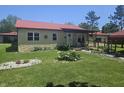 Well-maintained single-story home with a red roof and unique stone facade, surrounded by a lush green lawn at 705 S 450 E, Franklin, IN 46131