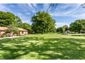 Expansive and well-maintained front yard with mature trees and lush green grass at 7110 N Layman Ave, Indianapolis, IN 46250