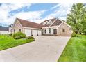 Beautiful brick home with a three-car garage and a concrete driveway at 720 Willow Pointe North Dr, Plainfield, IN 46168