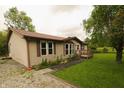 View of the home's side exterior, highlighting the well-manicured lawn and beautiful landscaping at 7214 W Reformatory Rd, Fortville, IN 46040