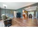 Inviting living room with hardwood floors, neutral tones, and an open layout to the kitchen and dining areas at 7214 W Reformatory Rd, Fortville, IN 46040