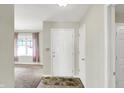 Bright entryway with neutral walls, tiled floor, and a view into the carpeted living area at 7238 Moultrie Dr, Indianapolis, IN 46217