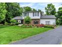 Attractive two-story home with brick and siding, a well-manicured lawn, and an asphalt driveway at 7255 Haverhill Ct, Indianapolis, IN 46250