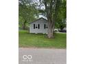 Single-story home with gray siding and mature trees in a spacious yard at 7504 N Green Meadows, Fairland, IN 46126