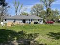 Spacious backyard with a patio area, grill, and a lawn perfect for outdoor activities at 7731 Scarborough S Blvd, Indianapolis, IN 46256
