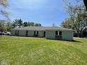 Charming single-story home with a well-maintained lawn and inviting facade on a sunny day at 7731 Scarborough S Blvd, Indianapolis, IN 46256