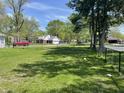 Residential street view with mature trees and well-kept lawns, in a quiet neighborhood at 7731 Scarborough S Blvd, Indianapolis, IN 46256