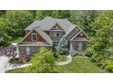 Attractive brick home with mature trees and a beautifully landscaped front yard at 7744 Preservation Dr, Indianapolis, IN 46278
