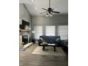 Inviting living room featuring a fireplace, comfortable sofas, and a stylish ceiling fan at 7838 Chesapeake E Dr, Indianapolis, IN 46236