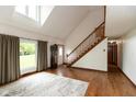 Bright foyer with hardwood floors, stairway, high ceilings, and a large window at 8465 Hilltop Ln, Martinsville, IN 46151