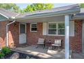 Inviting front porch with seating area and charming decor at 9104 W Lone Beech Dr, Muncie, IN 47304