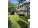 Charming two-story townhome featuring a well-maintained lawn and convenient attached garages at 9535 Longwell Dr, Indianapolis, IN 46240