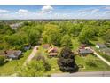 An aerial view of a charming home surrounded by lush greenery, showcasing the serene neighborhood at 102 N Whitcomb Ave, Indianapolis, IN 46224
