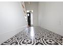Bright foyer with a decorative tile floor and a view of the staircase and front door at 1156 Spruce St, Indianapolis, IN 46203