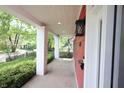 Covered porch with brick columns overlooks the neighborhood and features updated lighting at 1156 Spruce St, Indianapolis, IN 46203