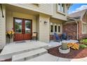 Inviting front entrance with double doors, a cozy seating area, and landscaped garden beds at 1219 Driftwood Dr, Carmel, IN 46033