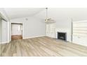 Bright, open living room with vaulted ceiling, wood floors, fireplace, and built-in shelving at 12289 Charing Cross Rd, Carmel, IN 46033