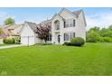 This two-story home offers a well-manicured lawn and traditional architectural details at 13896 Fernleaf Way, Carmel, IN 46033