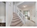 Bright foyer features carpeted stairs and neutral walls, creating a welcoming entrance at 13896 Fernleaf Way, Carmel, IN 46033