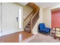 Inviting foyer showcasing hardwood floors, stairs to the upper level, and a bright front door at 1452 Brookside N Ct, Columbus, IN 47201