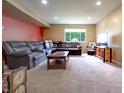 Comfortable living room with a gray sofa, area rug, window, and recessed lighting at 1452 Brookside N Ct, Columbus, IN 47201