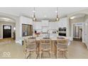 Bright kitchen featuring white cabinets, stainless steel appliances, and seating at the island at 14877 Higgins Dr, Westfield, IN 46074
